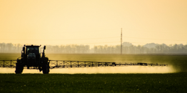 tractor spraying pesticide safely